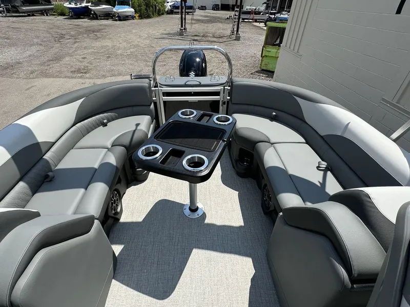 Slide: The Image of 2025 Tahoe LTZ 2385 QL pontoon boat interior with seating and table. - 11