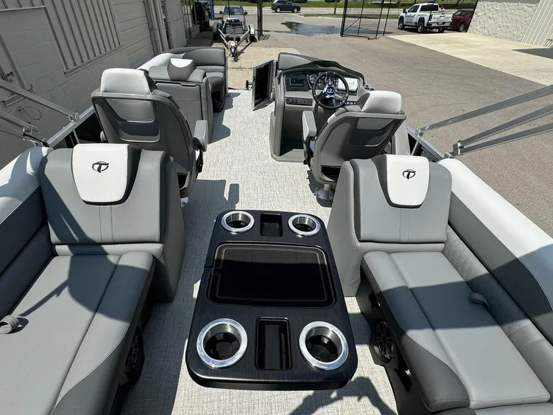 Slide: The Image of 2025 Tahoe LTZ 2385 QL pontoon boat interior with luxurious seating and modern dashboard. - 14