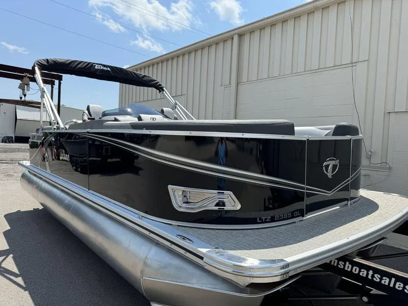 Slide: The Image of 2025 Tahoe LTZ 2385 QL pontoon boat with sleek black exterior. - 2