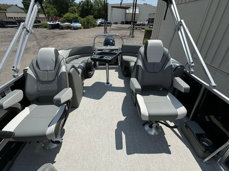 Slide: The Image of 2025 Tahoe LTZ 2385 QL pontoon boat interior with gray seating and helm station. - 7