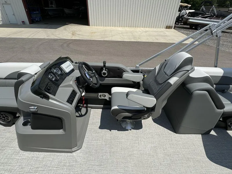 Slide: The Image of 2025 Tahoe LTZ 2385 QL boat interior with captain's chair and control console. - 8