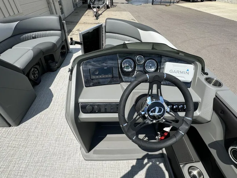 Slide: The Image of 2025 Tahoe LTZ 2385 QL boat interior with steering wheel and Garmin navigation system. - 9