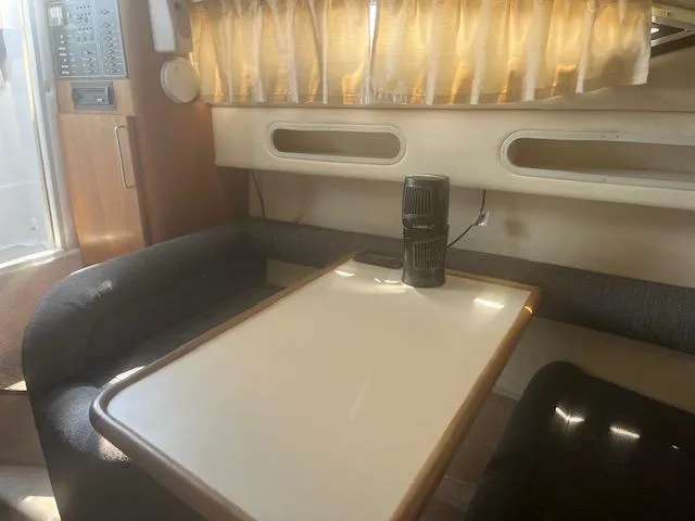 Slide: The Image of Interior of a 1995 Monterey 296 Cruiser with dining table and seating area. - 11