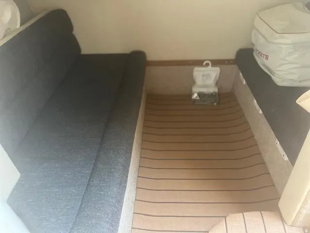 Slide: The Image of Interior cabin of a 1995 Monterey 296 Cruiser with seating and storage. - 14