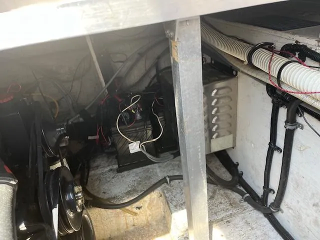 Slide: The Image of Engine compartment of a 1995 Monterey 296 Cruiser boat showing mechanical and electrical components. - 19