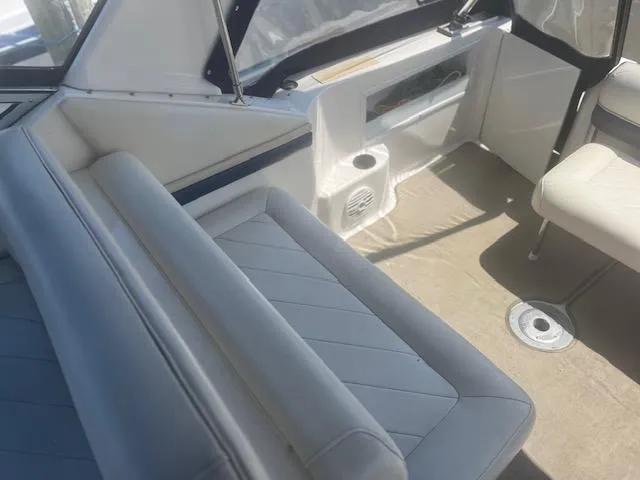 Slide: The Image of Interior of a 1995 Monterey 296 Cruiser boat with white leather seating. - 7