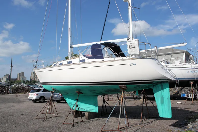 Slide: The Image of 1988 Tartan 34-2 Scheel Keel sailboat on stands in a marina. - 1