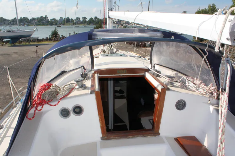 Slide: The Image of 1988 Tartan 34-2 Scheel Keel sailboat cockpit with open cabin entrance. - 11