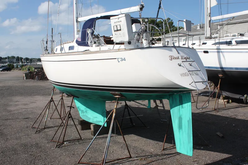 Slide: The Image of 1988 Tartan 34-2 Scheel Keel sailboat on stands, displayed outdoors. - 2