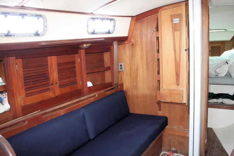 Slide: The Image of Interior of 1988 Tartan 34-2 Scheel Keel sailboat with wooden cabinetry and blue seating. - 21