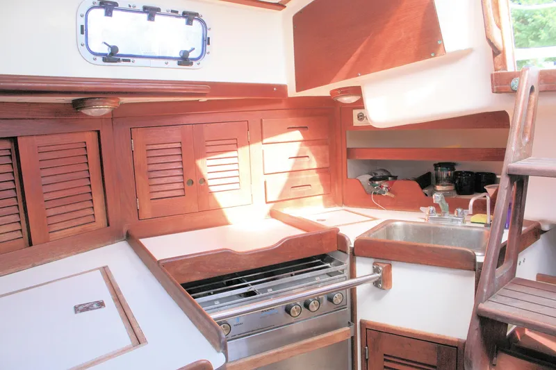 Slide: The Image of 1988 Tartan 34-2 Scheel Keel yacht interior with wooden cabinetry and compact kitchen. - 27