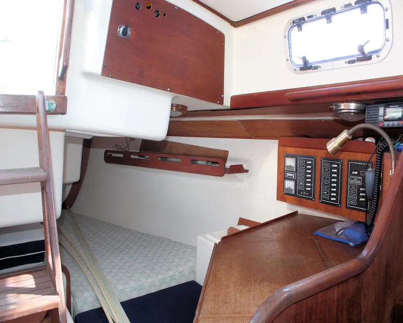 Slide: The Image of Interior of 1988 Tartan 34-2 Scheel Keel sailboat with wood paneling and navigation equipment. - 29