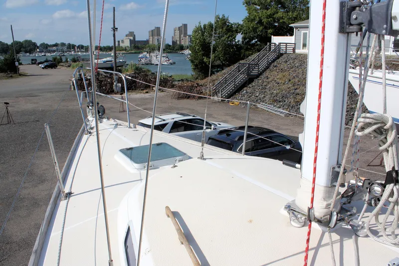 Slide: The Image of 1988 Tartan 34-2 Scheel Keel sailboat docked, overlooking marina and cityscape. - 7