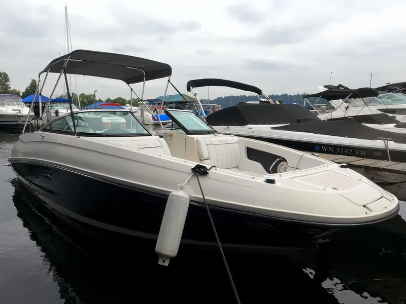 Slide: The Image of 2014 Sea Ray 240 Sundeck Outboard boat docked in a marina. - 1