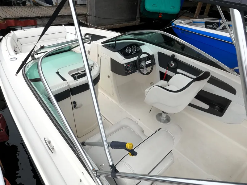 Slide: The Image of 2014 Sea Ray 240 Sundeck Outboard interior with helm and seating. - 14