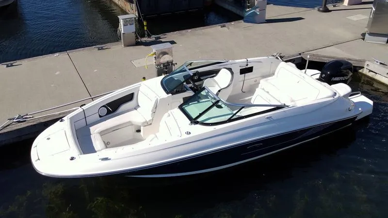 Slide: The Image of 2014 Sea Ray 240 Sundeck Outboard boat docked at a marina. - 17