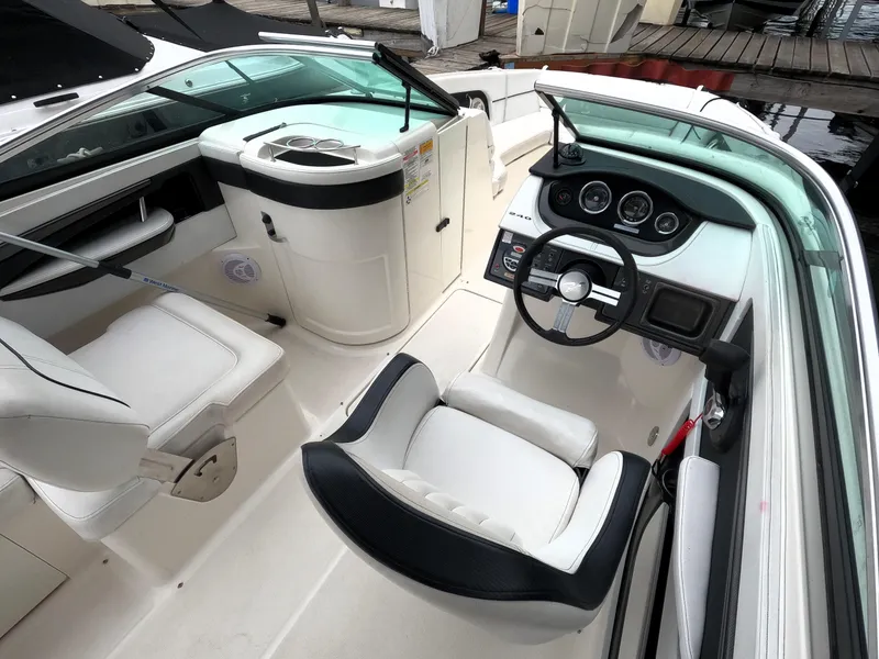 Slide: The Image of 2014 Sea Ray 240 Sundeck Outboard boat interior with helm and seating. - 5