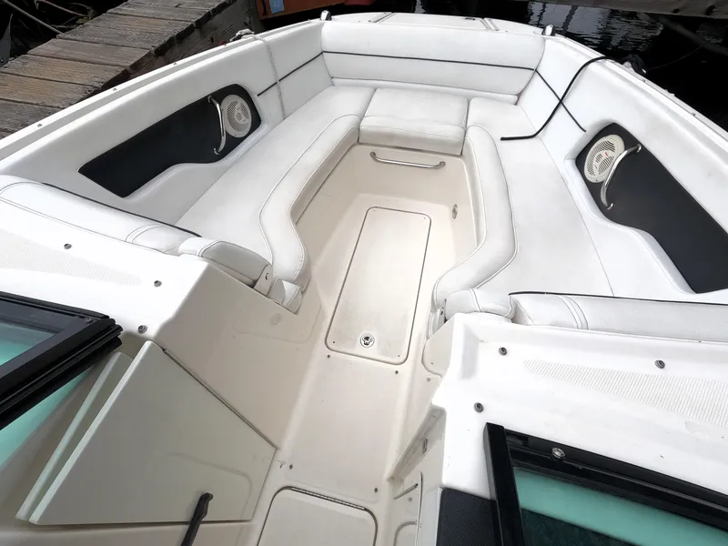 Slide: The Image of 2014 Sea Ray 240 Sundeck Outboard boat interior with white seating and storage compartments. - 6