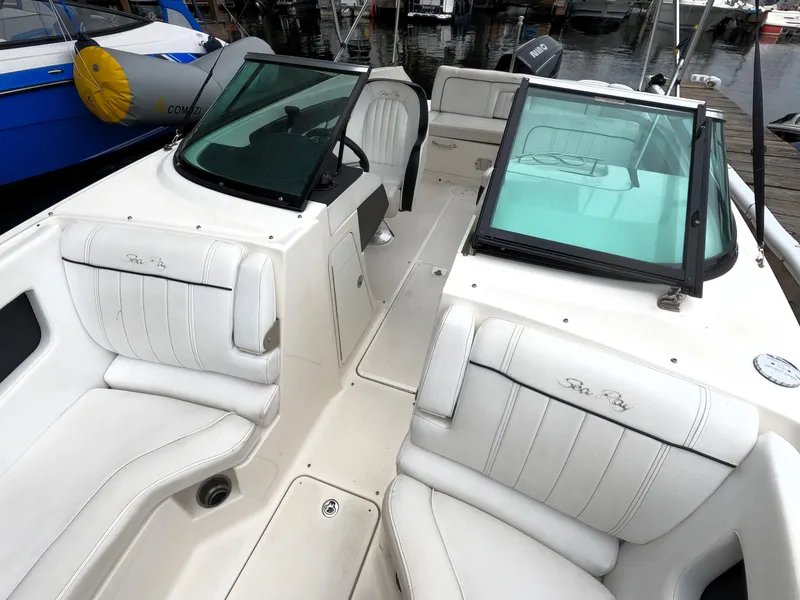Slide: The Image of 2014 Sea Ray 240 Sundeck Outboard interior with white seating and windshield. - 7