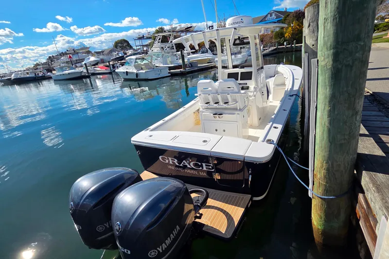 Slide: The Image of 2020 Regulator 25 boat docked, featuring twin Yamaha 250 engines, clear sky background. - 3