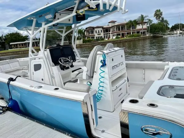 Slide: The Image of 2021 Sea Fox 288 Commander boat docked by waterfront homes. - 1