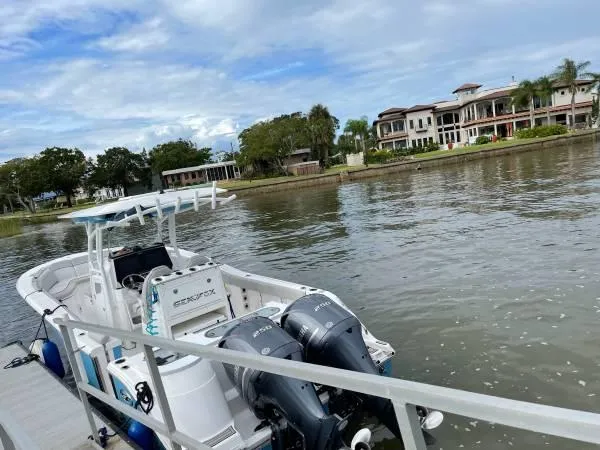 Slide: The Image of 2021 Sea Fox 288 Commander boat docked by waterfront homes. - 3
