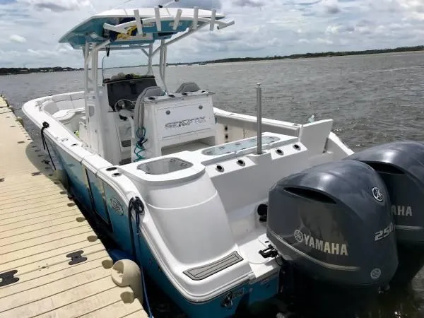 Slide: The Image of 2021 Sea Fox 288 Commander boat docked, featuring twin Yamaha 250 engines. - 4