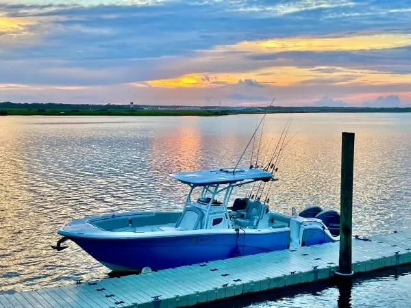 Slide: The Image of 2021 Sea Fox 288 Commander boat docked at sunset on a serene lake. - 6