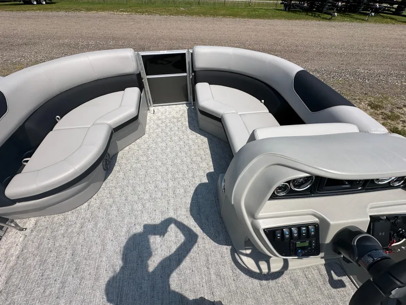 Slide: The Image of 2025 South Bay 220RSLE pontoon boat interior with plush seating and modern dashboard. - 2