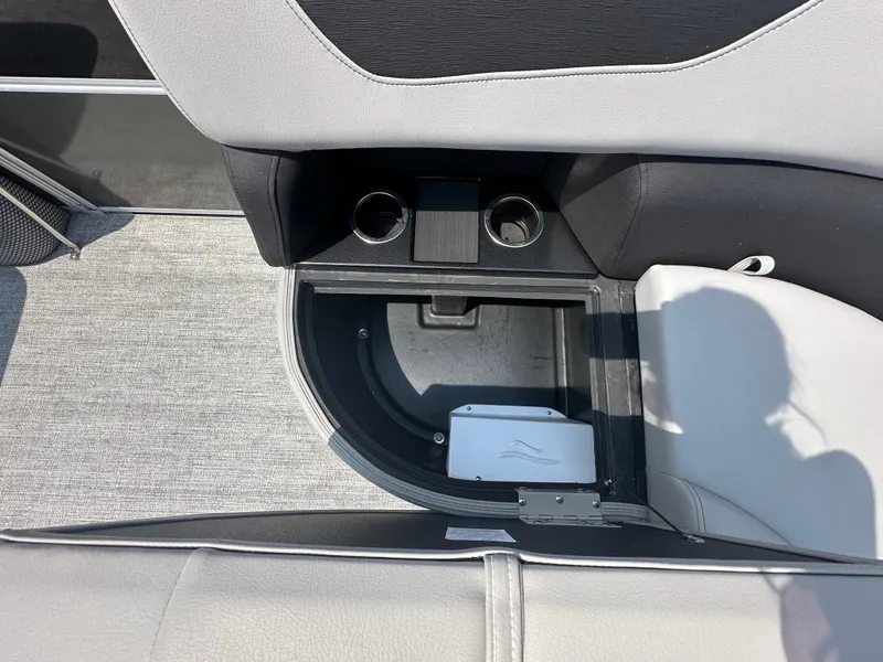 Slide: The Image of Storage compartment and cup holders in 2025 South Bay 220RSLE boat. - 9