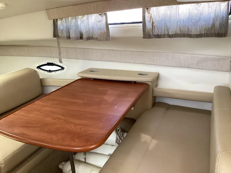 Slide: The Image of 2004 Bayliner 2655 Ciera cabin interior with dining table and seating. - 19