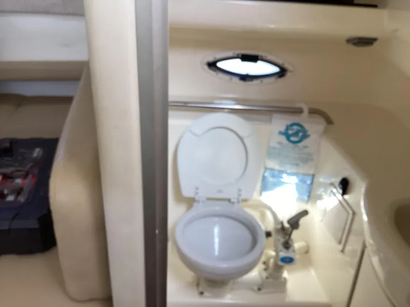 Slide: The Image of 2004 Bayliner 2655 Ciera boat interior with toilet and small window. - 21