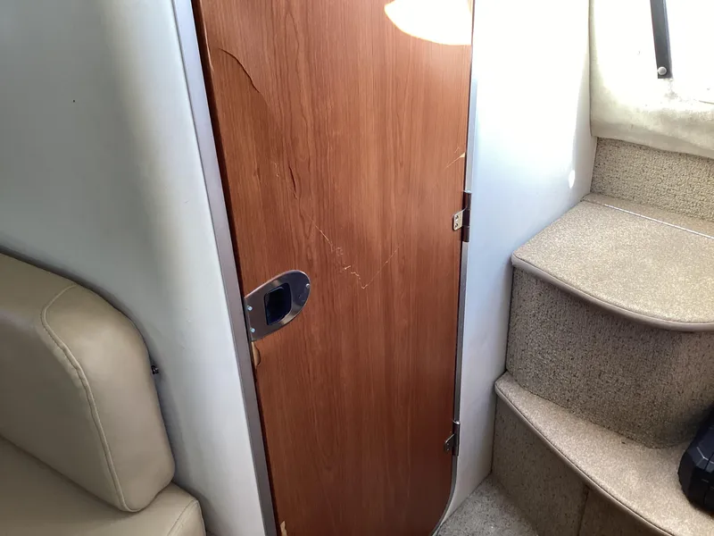 Slide: The Image of Interior cabin door and stairs of a 2004 Bayliner 2655 Ciera boat. - 22