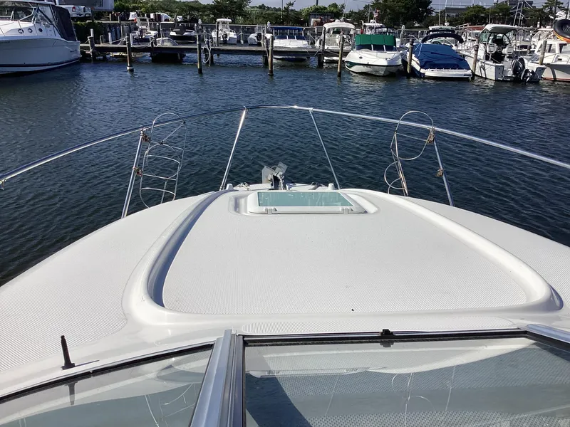 Slide: The Image of 2004 Bayliner 2655 Ciera boat docked at a marina, view from the bow. - 12