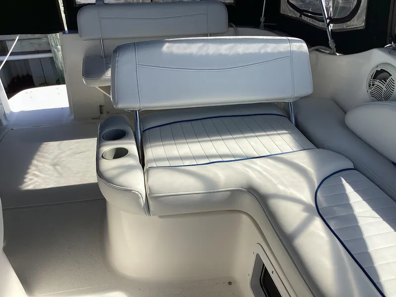 Slide: The Image of 2004 Bayliner 2655 Ciera boat interior with white leather seating and cup holders. - 11