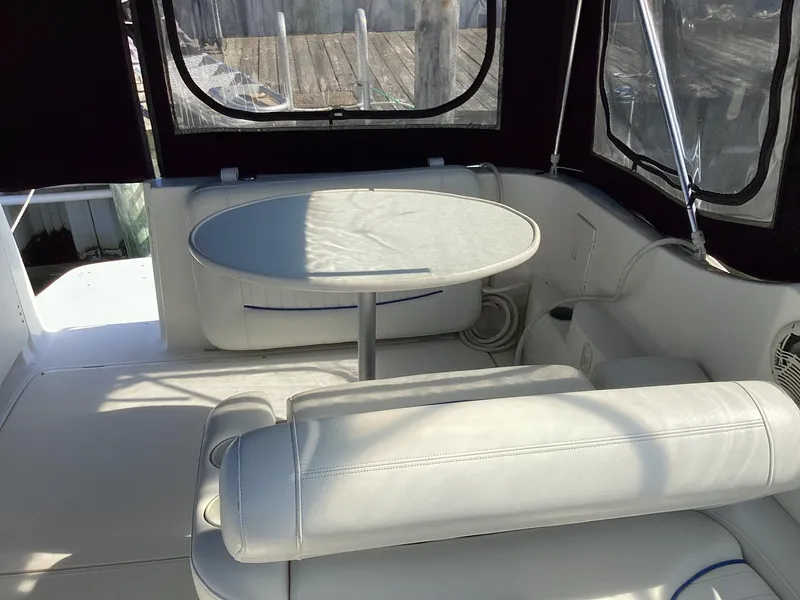 Slide: The Image of 2004 Bayliner 2655 Ciera boat interior with white seating and table. - 9