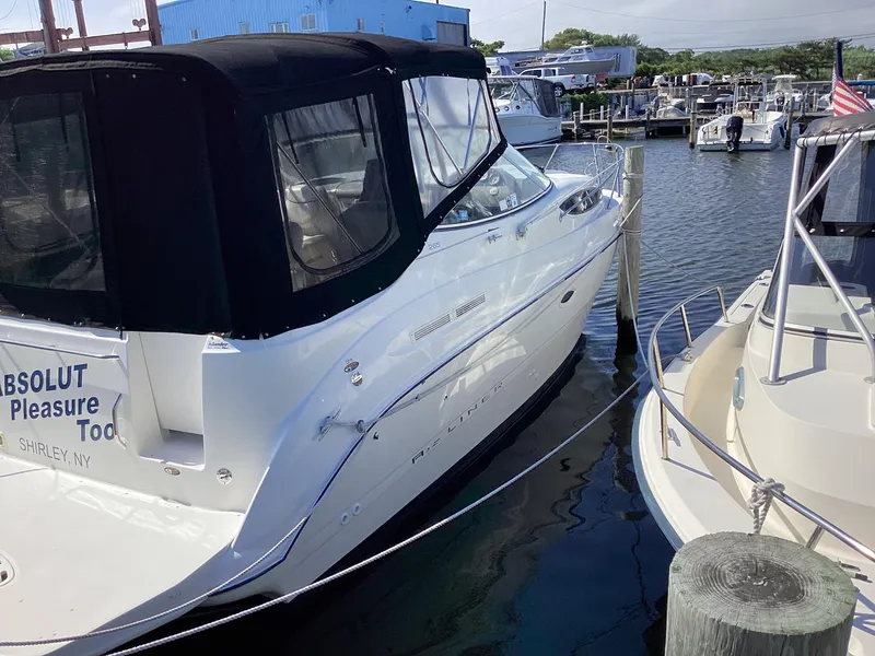 Slide: The Image of 2004 Bayliner 2655 Ciera docked at a marina with black canvas cover. - 3