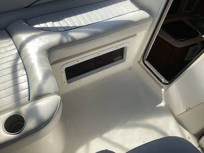 Slide: The Image of 2004 Bayliner 2655 Ciera boat interior seating area with cup holder. - 13