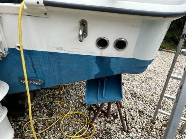 Slide: The Image of Close-up of a 2004 Boston Whaler 320 Outrage boat hull with yellow hose. - 11