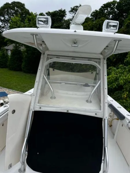 Slide: The Image of 2004 Boston Whaler 320 Outrage boat with enclosed helm and overhead lights. - 12