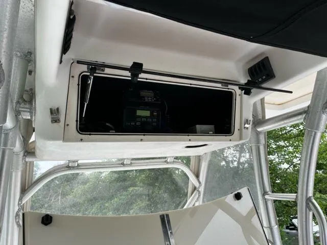 Slide: The Image of 2004 Boston Whaler 320 Outrage electronics compartment with open storage hatch. - 15