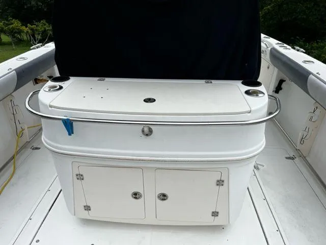 Slide: The Image of 2004 Boston Whaler 320 Outrage center console with storage compartments. - 19