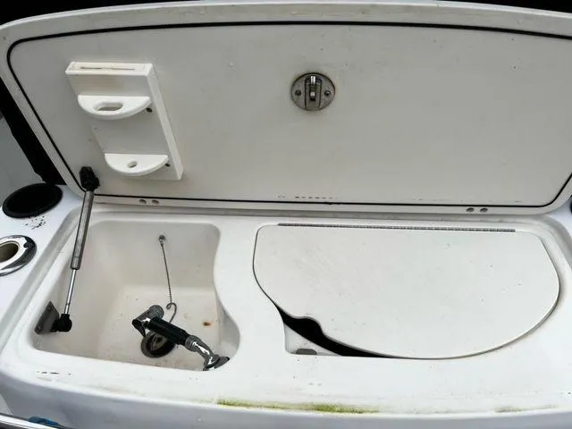 Slide: The Image of Boston Whaler 320 Outrage 2004 boat sink and storage compartment. - 20