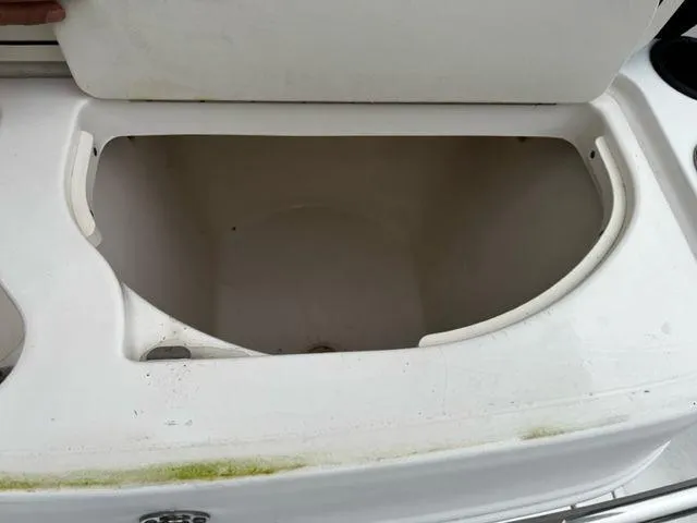 Slide: The Image of Open storage compartment on a 2004 Boston Whaler 320 Outrage boat. - 21