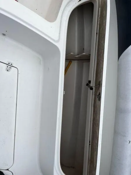 Slide: The Image of Open storage compartment on a 2004 Boston Whaler 320 Outrage boat. - 22