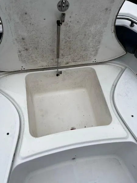 Slide: The Image of Open storage compartment on a 2004 Boston Whaler 320 Outrage boat. - 24