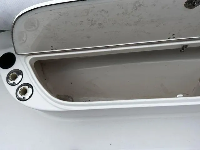 Slide: The Image of Open storage compartment on a 2004 Boston Whaler 320 Outrage boat. - 25