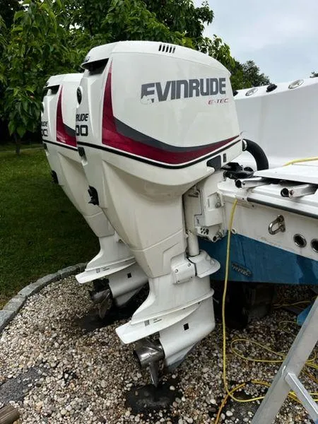 Slide: The Image of Twin Evinrude E-TEC outboard motors on a 2004 Boston Whaler 320 Outrage boat. - 30