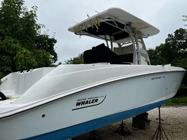 Slide: The Image of 2004 Boston Whaler 320 Outrage boat on stands, side view. - 8