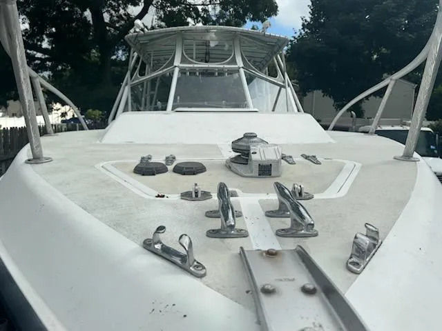 Slide: The Image of 1998 Contender 35 Express boat deck with metal fittings and windshield, viewed from the bow. - 6